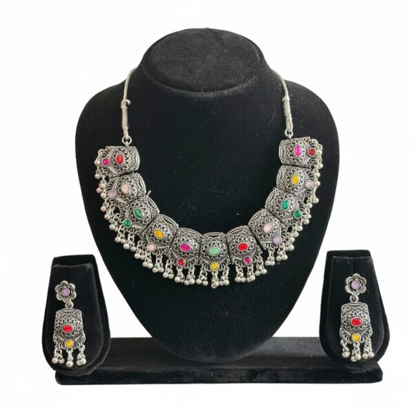 Oxidised Silver Multi-Color Stone Necklace Set image 1 Oxidised silver necklace set with multi-color stones and matching earrings displayed on a black jewellery stand.